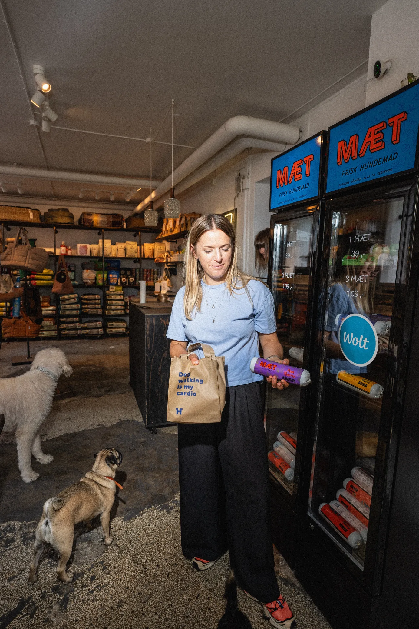 Stina Holm Rossen packing a Wolt order at the counter of her pet boutique